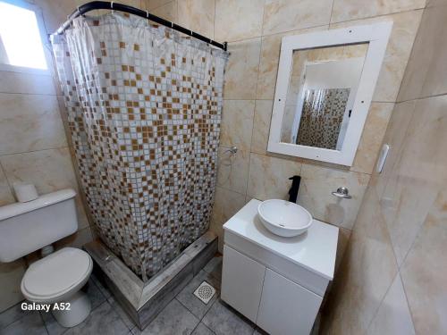 a bathroom with a shower with a toilet and a sink at Santa Lucia in Necochea