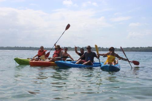 a group of people in kayaks on the water at Hospedaje Yarisnori in Bocas del Toro
