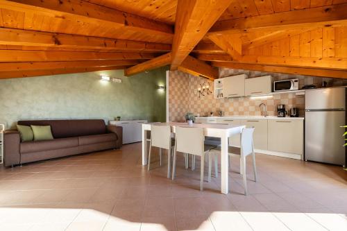 a kitchen and living room with a table and chairs at Appartamento La diMosa in Dro