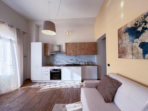 a living room with a couch and a kitchen at Albachiara Apartment in Lampedusa
