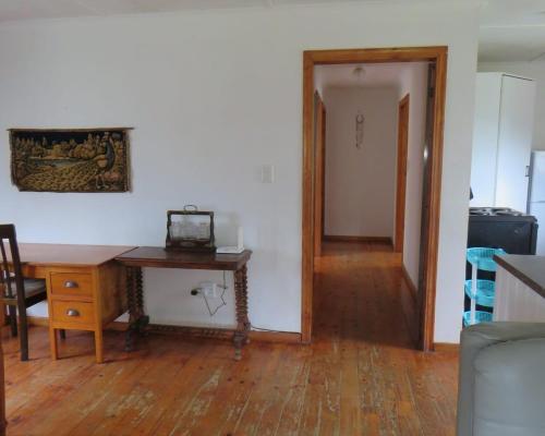 a room with a desk and a table and a hallway at Misty View Farm Stay in Towerhill