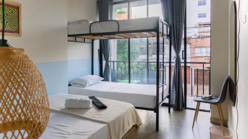 a room with two bunk beds and a window at Selva House in Medellín