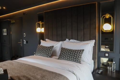 a bedroom with a large white bed with pillows at Y Seler in Aberaeron