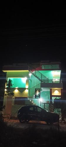 a car parked in front of a building at night at Budha Home Stay in Hampi