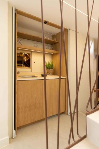 une cuisine avec des placards en bois et un comptoir dans l'établissement Le Relais de la Godasse, à Reyrieux