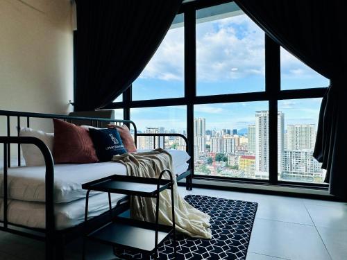 a living room with a couch and a large window at a29 seaview luxury 3BR-10PAX URBAN NETFLIX in Jelutong