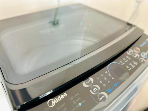 a close up of a toaster oven remote control at a29 seaview luxury 3BR-10PAX URBAN NETFLIX in Jelutong