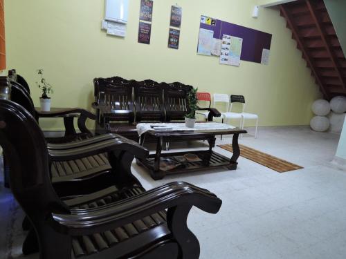 a living room with chairs and a table and a table at The Pillohouzzze in Melaka