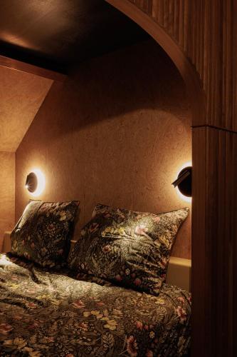 a bedroom with a bed with two pillows on it at HoveniersHuis in Anzegem