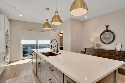 a kitchen with a sink and a clock on the wall at Main Street Retreat Chatt in Chattanooga
