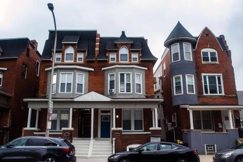 a large house with cars parked in front of it at Diamond Suites Philadelphia Center in Philadelphia
