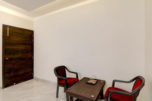a room with a table and two chairs and a door at Collection O Siddharth Near A to Z Electronics in Kānpur