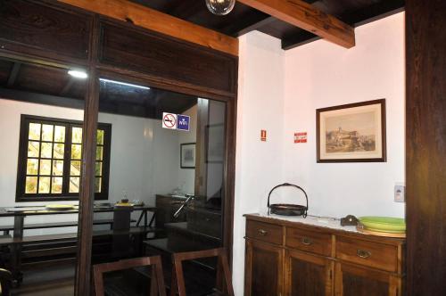 a room with a door open to a dining room at Quinta O Refúgio in São Vicente