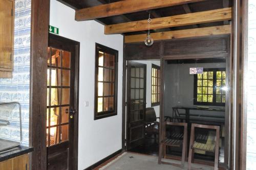 an open door to a room with a table at Quinta O Refúgio in São Vicente
