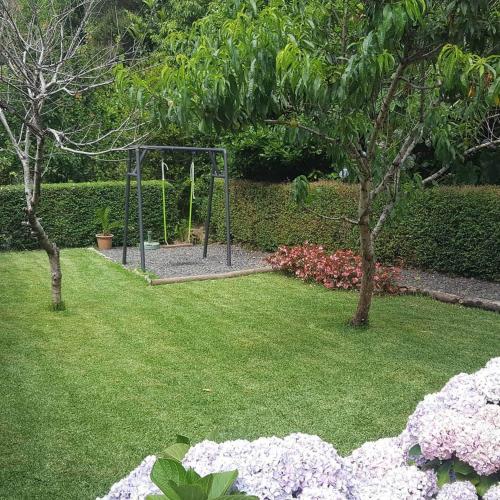 a park with a swing set in the grass at Quinta O Refúgio in São Vicente