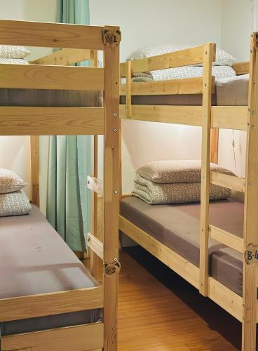 a couple of bunk beds in a room at One House in Gongliao
