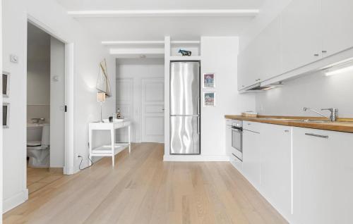 a white kitchen with a sink and a refrigerator at 2 Bedroom Stunning Home In Gråsten in Gråsten