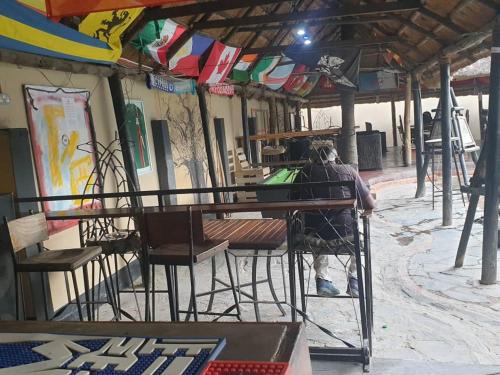 a person sitting at a table in a building at Lusaka Backpackers in Lusaka