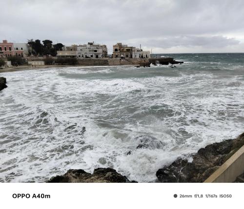 a view of the ocean with a group of buildings at Case vacanze LULU in Seclì