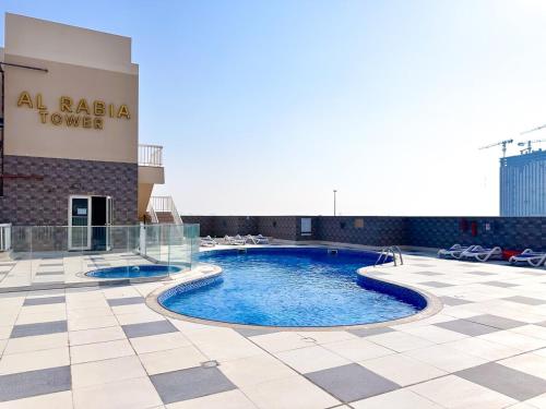 a pool on the roof of a hotel at Amazing 2 Bedroom in Al Rabia Tower in Majan 6PPL in Dubai