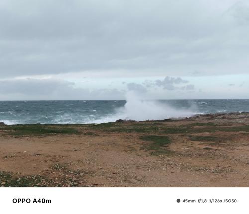 a picture of the ocean with smoke coming from the ocean at Case vacanze LULU in Seclì