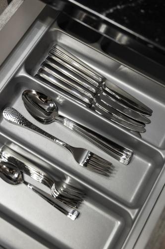 a group of silver forks and spoons in a drawer at GpxClr-LuxHarmonyGrandSuite in Larisa