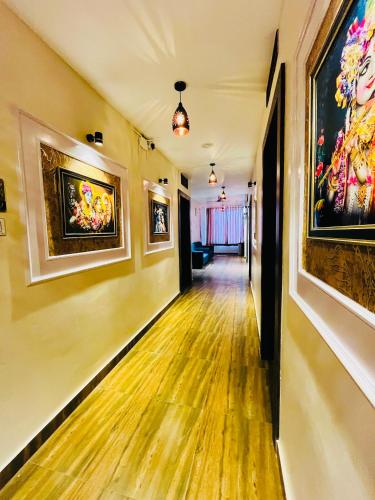 an empty hallway with paintings on the walls at Shubh Laxmi Residence in Ajmer
