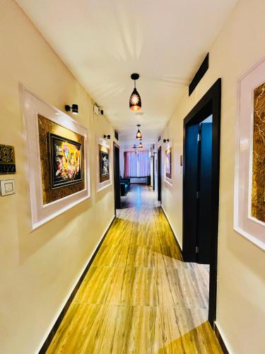 an empty hallway with paintings on the walls at Shubh Laxmi Residence in Ajmer