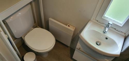 une petite salle de bain avec toilettes et lavabo dans l'établissement Holidayhomepoujol mobile gite, à Montfermier
