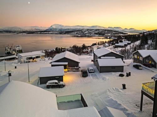 an aerial view of a town with snow covered roofs at Eide Aurora Apartement in Tromsø