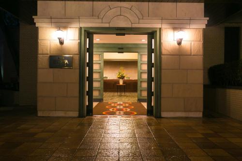 an entrance to a building at night with lights at Resorpia Beppu in Beppu