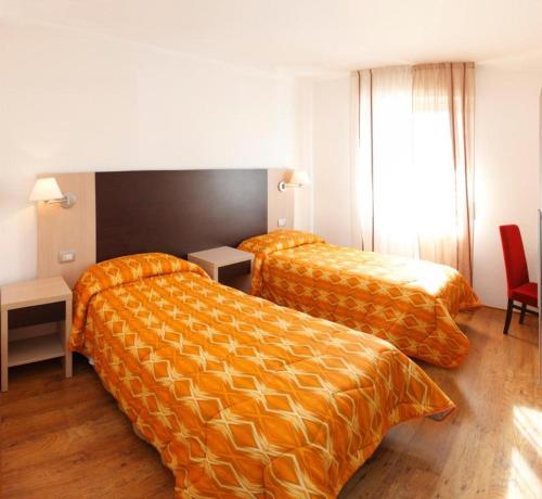 Postel nebo postele na pokoji v ubytování Hotel Garibaldi