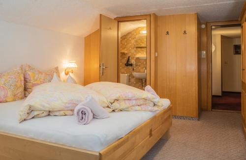 a bedroom with a bed with two pillows on it at Frühstückspension Gweil in Sankt Gallenkirch