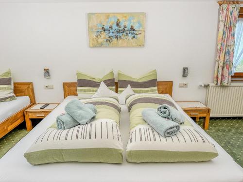 a bedroom with two beds with towels on them at Frühstückspension Gweil in Sankt Gallenkirch