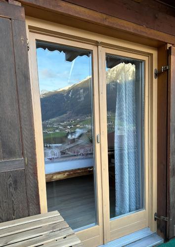 a window with a view of a mountain at Frühstückspension Gweil in Sankt Gallenkirch