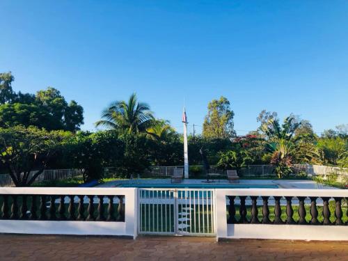 a white fence in front of a pool at Villa SAIDIA climatisée avec PISCINE in Diego Suarez