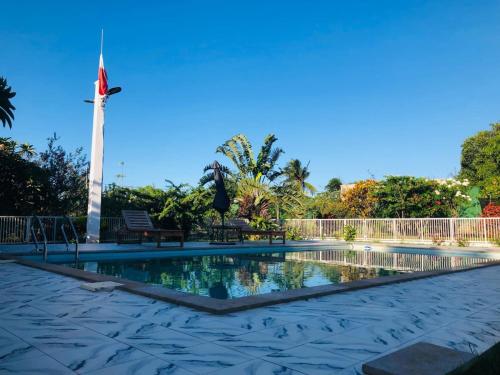 a swimming pool with a monument in the background at Villa SAIDIA climatisée avec PISCINE in Diego Suarez