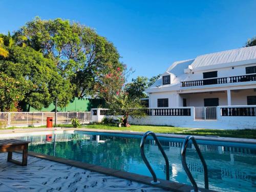 a swimming pool in front of a house at Villa SAIDIA climatisée avec PISCINE in Diego Suarez
