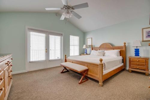 a bedroom with a bed and a ceiling fan at Sea Esta Suite - Duval Square in Key West