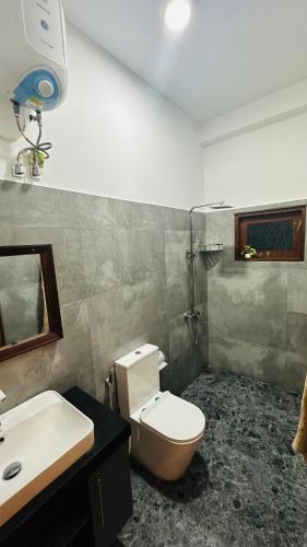 a bathroom with a toilet and a sink at Villa J Ambalangoda in Ambalangoda