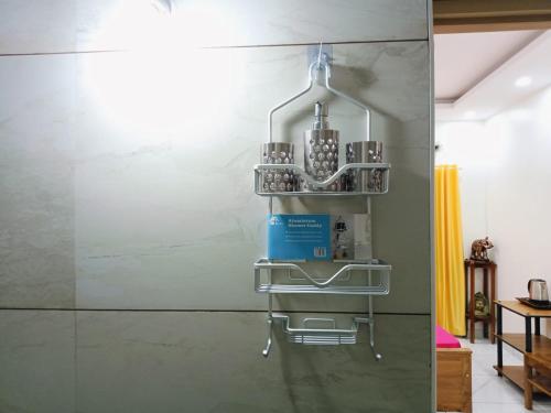 a kitchen with a shelf on the wall at Pepper Jazz Varkala in Varkala