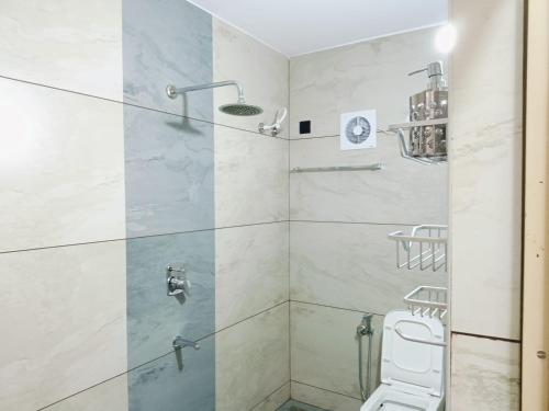 a bathroom with a shower with a toilet at Pepper Jazz Varkala in Varkala