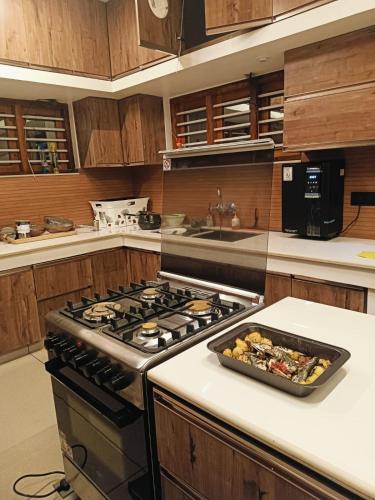 a kitchen with a stove and a pan of food on a counter at Pepper Jazz Varkala in Varkala