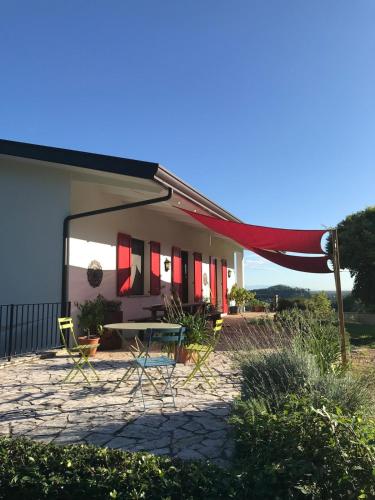 a patio with chairs and a table in front of a building at Holiday home with alpine panorama in Teolo