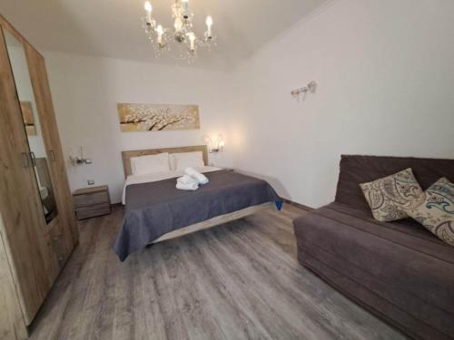 a bedroom with a bed and a couch at Melirito in Olympiada