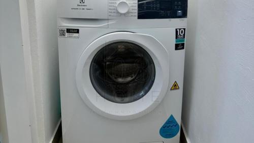 a white washing machine sitting next to a wall at Sentral 108 Home Brickfields Bangsar Kuala Lumpur 2-5Pax in Kuala Lumpur