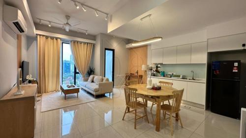 a kitchen and living room with a table and a couch at Sentral 108 Home Brickfields Bangsar Kuala Lumpur 2-5Pax in Kuala Lumpur