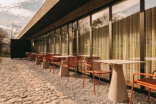 a row of tables and chairs in front of a building at Estrela Serenity - Resort in Folgosinho