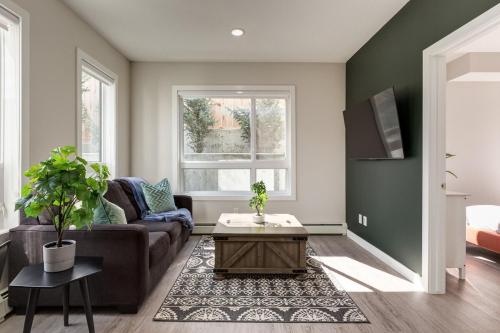 a living room with a couch and a coffee table at Free Heated Parking, Close to DT, Pet Friendly in Calgary