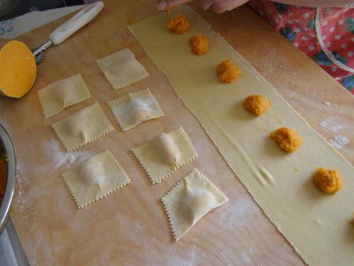 a cutting board with uncooked wontons on a cutting board at Agriturismo Collesassi in Montalcino